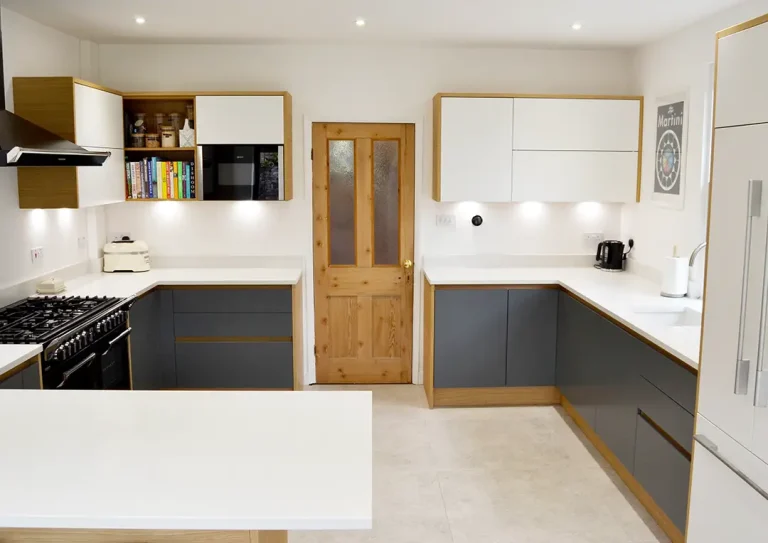 A white and grey handleless kitchen with hob.