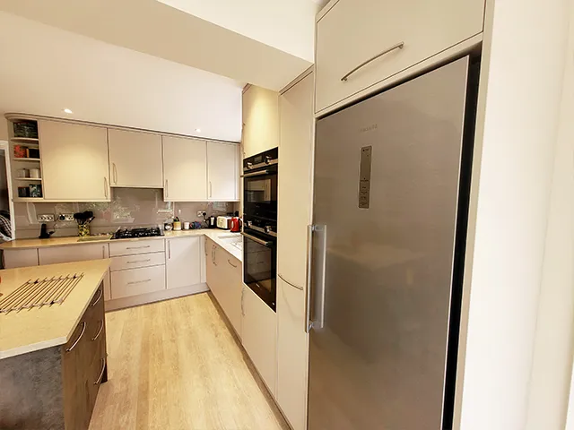 Large integrated fridge freezer with Superior Matt Cashmere coloured kitchen units.