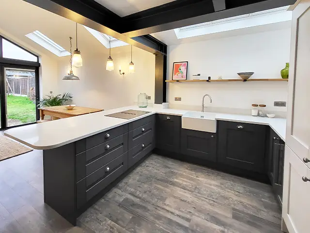A white marbled quartz breakfast bar in an open-plan living space set in a newly built house extension.