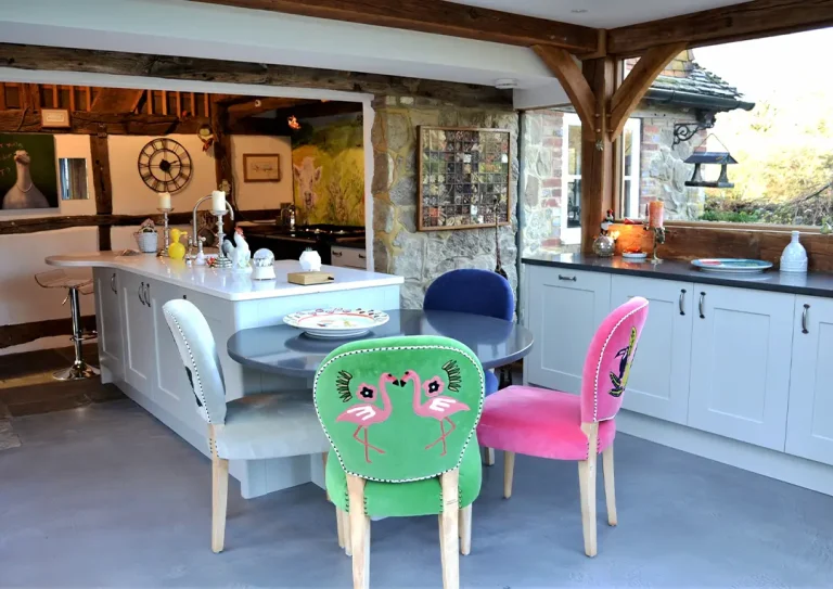 Wide shot of a kitchen extension with a large kitchen island and a quartz worktop dining area attached to it.