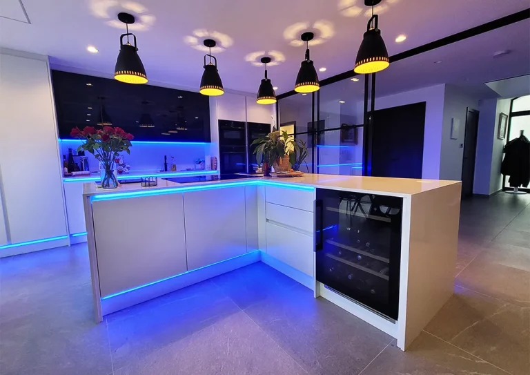 Ultra modern kitchen with flat slab white painted doors, wine cooler and RGB LED strip lighting