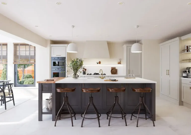 A wide shot of a mock in-frame kitchen with a large kitchen island incorporating a breakfast bar and four bar stools.