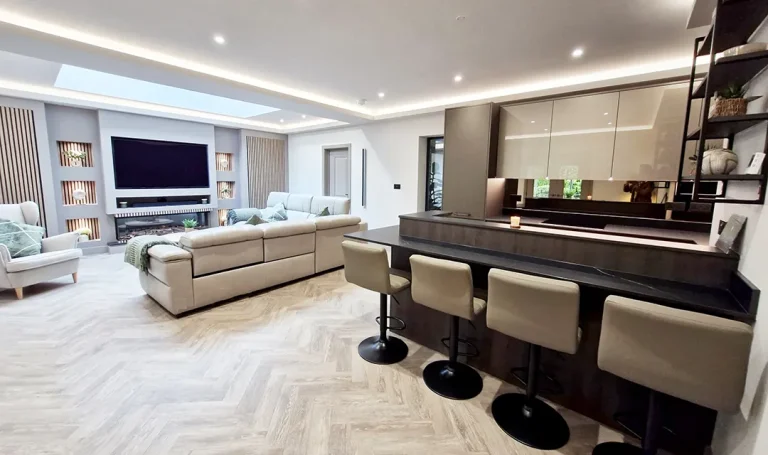Bar and kitchen in a media room with a mix of Slab Doors in Co-ordinating Textures and under cabinet strip Led lighting.