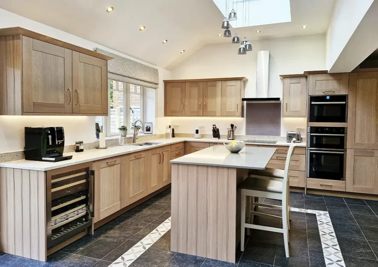 Kitchen with stained Oak Shaker doors, breakfast bar with stools, Quartz worktops and a induction hob.